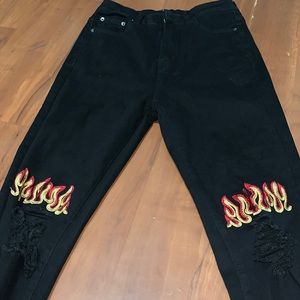 Black skinny jeans with flames and rips on knee